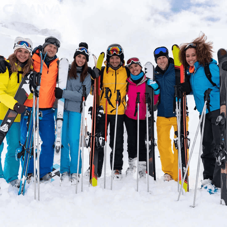 Gruppe von Freunden, die lächelnd mit Ski und Stöcken im Schnee stehen